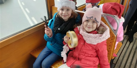 Powiększ grafikę: Dziewczynki grające na instrumentach podczas przejazdu tramwajem