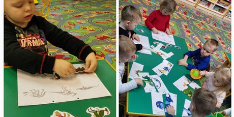 Powiększ grafikę: dzieci pracują przy stoliku, uikładają sylwety dinozaurów