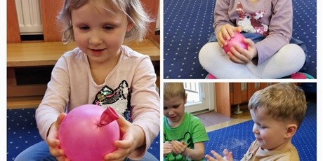 Powiększ grafikę: zajęcia z fizykiem - zima i niska temperatura, Kasia trzyma w rączkach zimny balon, Szymon doświadcza kontaktu z cząsteczkami w stanie gazu